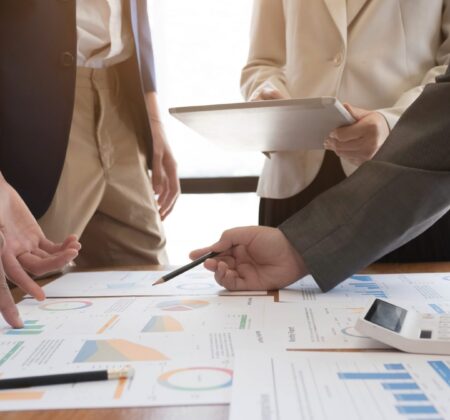 Asian business adviser meeting to analyze and discuss the situation on the financial report in the meeting room.Investment Consultant,Financial Consultant,Financial advisor and accounting concept.