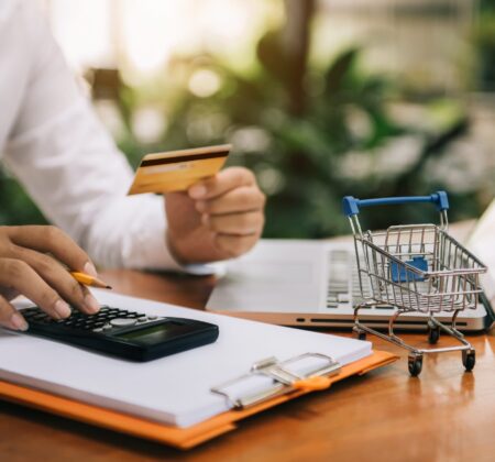 Online shopping concept, Male using calculator with credit card shopping online is a form of electronic commerce from a seller over internet.